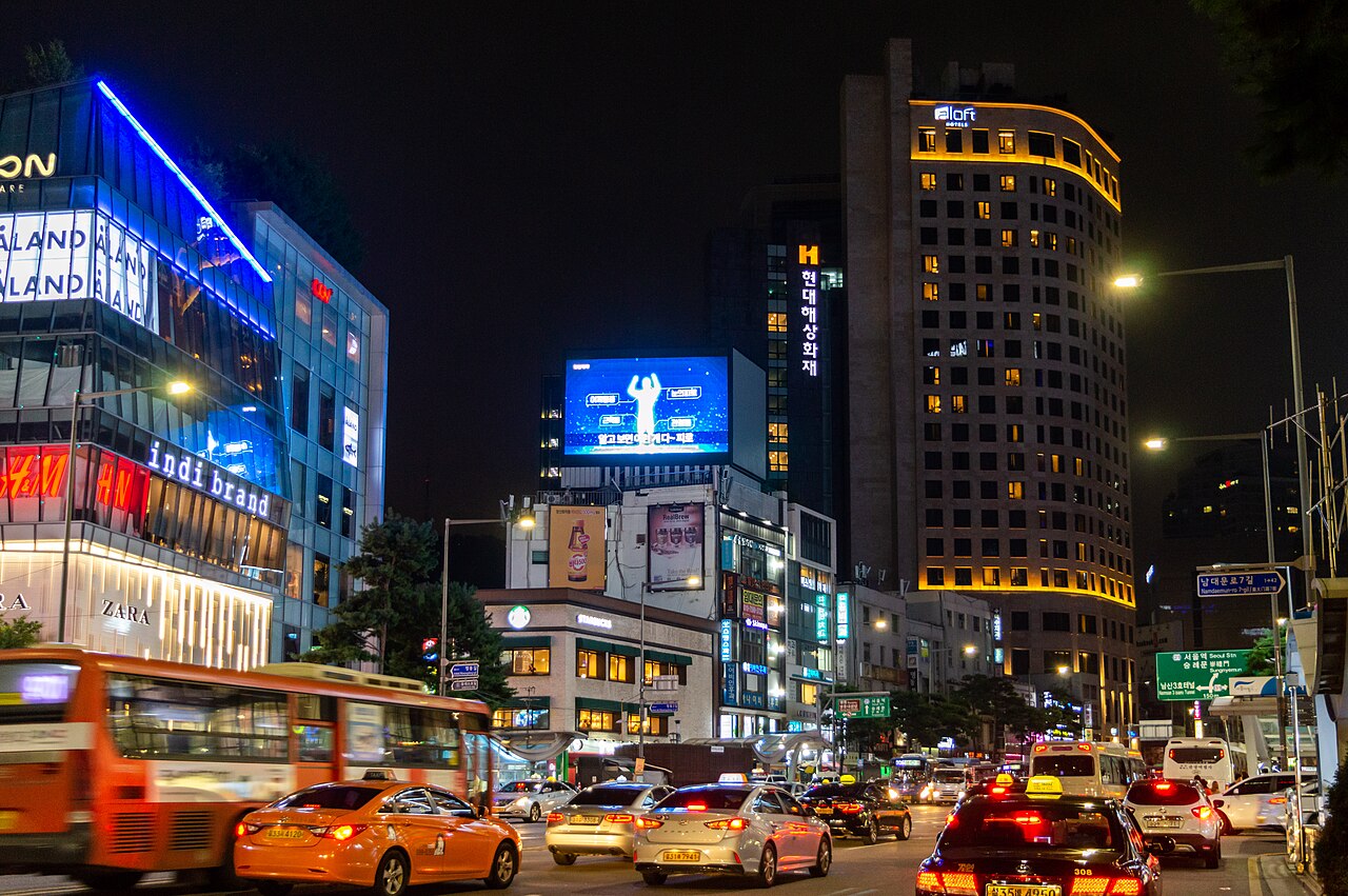 Myeongdong at night, Seoul, lit shopfronts and traffic
