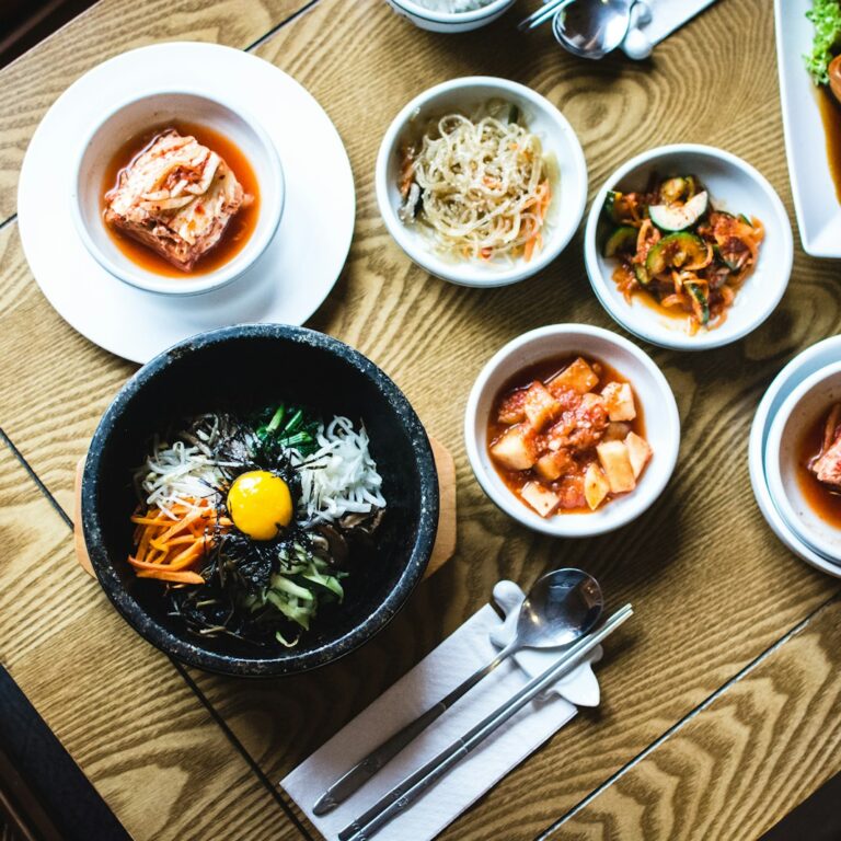 A Korean table set with rice, stew and many small side dishes