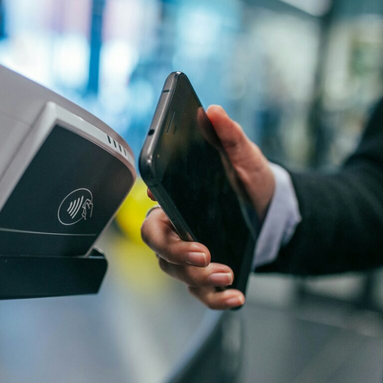 A phone held against a contactless payment terminal